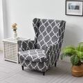 Dark grey wingback chair cover featuring a white geometric pattern in a cozy home setting - Vine Pattern Gray