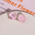 Macro detail of pink star-shaped resin charms with opal finish and clear core textures - Light Pink