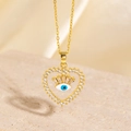 Macro view of heart-shaped evil eye pendant with blue enamel and zircon details - Style C (Blue Eyelash Evil Eye) / 14K Gold / Gold