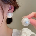 Elegant gold-plated hook earrings featuring large white baroque pearls on model's ear - Large Sphere Studs (8#) / White Pearl