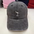 Close-up of white flamingo embroidery on washed cotton fabric of a dark gray baseball cap - M (56-58cm) / Washed Black