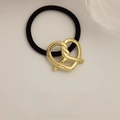 Minimalist black elastic hair tie featuring a polished gold metal knotted heart charm - Twisted Heart Gold