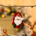 Detail of Santa Claus plush ornament hanging on a tree branch with festive bokeh lights - Santa Claus