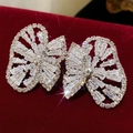 Close-up of sparkling bow earrings with rhinestones on a red velvet background - 25# Silver Zirconia Bow Stud Earrings