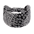 Detail view of wide black floral yoga headband with soft fabric and elastic back - Black Background With White Floral