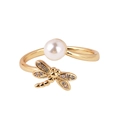 Detail of adjustable gold ring featuring a pearl and a micro-pave dragonfly charm - Dragonfly Pearl Style
