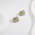 Detail of fan-shaped silver stud earrings featuring smooth yellow-green cat eye stones - Yellow