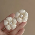 Detail of vintage flower tassel earrings with central pearl shown in hand - 5# Coated Fabric Pearl Flower Studs (HE15735)