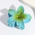 Detail of blue and green Plumeria flower hair claw clip with strong resin grip teeth - Blue