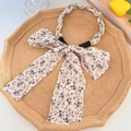 Floral print hairband with purple flowers, large bow, and pearl chain braid design - Beige with Purple Floral