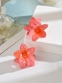Detail of two translucent coral pink flower hair claws with orange center on stone background - Orange Red (Single Piece)