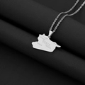 Detailed close-up of silver Syria map pendant with engraved city names on black fabric - Etching / Steel