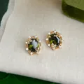 Elegant gold earrings with olive green oval stones and butterfly zircon details - 5586 Butterfly Zircon