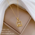 Detail view of gold-tone bag pendant with crystals and LOVE engraving in a gift box - C505 Titanium Steel Chain Copper Micro-set Pendant