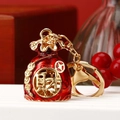 Lucky red money bag keychain with gold enamel finish and fortune character detail - Burgundy Fortune Bag