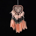 Pink heart-shaped dream catcher with delicate lace, feathers, and beads on black backdrop - Heart Without Lights / Flesh Pink