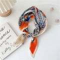 Pleated paisley scarf in orange and blue silk, tied on a white desk for styling - Three-Color Paisley Beige Orange