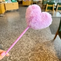 Close-up of a cute purple pen featuring a fluffy heart-shaped plush ball top decoration - Purple