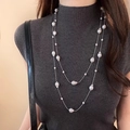 Double-layered long necklace with baroque pearls and silver beads on a gray sweater - Irregular Pearl + Silver-Tone Chain