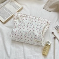 Detailed close-up of floral lace cosmetic bag with brushes and skincare products - Jacquard Pink Cherry