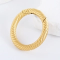 Detailed macro view of a French retro gold sandblasted geometric twisted bag buckle. - Double Ring T-Bar Geometric Buckle