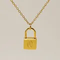 Minimalist gold necklace with a delicate lock pendant featuring an engraved letter Q - Letter Q Style