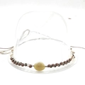 Close-up of bohemian hat band with bronze beads, shells, and a yellow polished stone detail - 13 Shell Woven Band