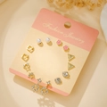 Titanium steel earring set featuring pearl, pink flower, and geometric rhinestone studs - Gold Pearl Sunflower (E1919-1)