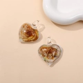 Detailed view of heart-shaped glass pendants with gold foil and inner floral motifs - Coffee (Type C)