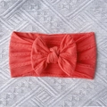 Detailed texture of coral pink cable knit nylon headband with large bow for babies - Watermelon red