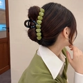 Black large hair claw clip with green heart-shaped resin stones on elegant updo - Green (Heart Decoration)