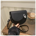 Detail of vintage black saddle bag with silver oval metal buckle and smooth leather texture - Black