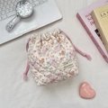 Detailed macro view of quilted cream storage bag with cute cartoon dog and floral patterns - Colorful Star Puppy