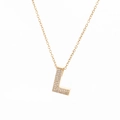 Close-up of gold-plated necklace featuring a letter L pendant with micro-pave crystals - Letter L