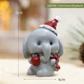 Miniature Christmas resin elephant figurine wearing a Santa hat and holding a red ornament - Christmas Elephant Style(24958)