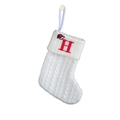 White knitted Christmas stocking featuring a red embroidered letter H and Santa hat decoration - White-Letter H