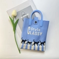 Detail of blue knit bag with black cat patterns and round handle on magazine background - Blue Cat Zebra Line