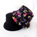 Detail view of foldable bucket hats with street style graffiti print and solid black color - Colorful Graffiti Print