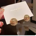 Close-up of golden dome earrings featuring textured ripple patterns on a display card - Metallic Ball Studs / Gold