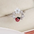 Detail of silver floral ring with a red enamel ladybug and sparkling white zircons - Ladybug (Silver Base)