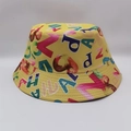 Detail of vibrant yellow bucket hat featuring colorful all-over graphic letter print - Yellow Colorful Letters
