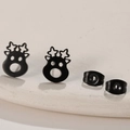 Macro detail of matte black reindeer stud earrings with butterfly backs on beige tray - Christmas Reindeer Blue / Black