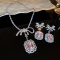 Close-up of silver bow jewelry set with pink square gemstones and sparkling rhinestones - 33# Necklace-Pink-Silver