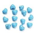 Flat lay of blue heart-shaped DIY craft beads for jewelry making on white background - 13X15mm / Sky Blue