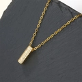 Golden column necklace with sparkling zircons displayed on dark stone background - Letter I (Pendant Only)
