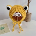 Yellow frog-shaped knitted baby bonnet with earflaps and big eyes on a stand - Yellow Frog - Not Lined