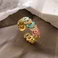Macro shot of colorful enamel gold ring with tiny zircons on textured paper - Adjustable Open / Colorful