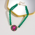 Detail of vintage gold necklace with green beads and pink crystal encrusted pendant - Retro Green Crystal Beaded Necklace with Round Pendant