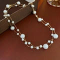 Double-layered gold plated necklace with alternating white pearls on a leather background - Gold (Real Gold Plated)