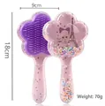 Pink floral-shaped cartoon massage hairbrush with colorful flowing beads and soft purple bristles - 02-Beauty Tower Purple